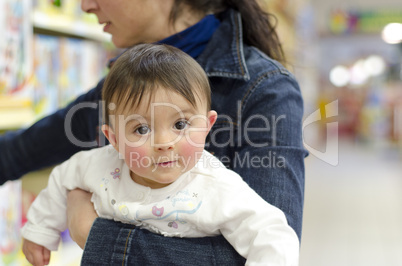 Baby Girl with her Mother in a Shop full of Toys