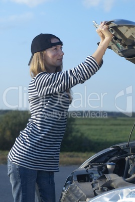 Young Blond Woman With Her Broken Car