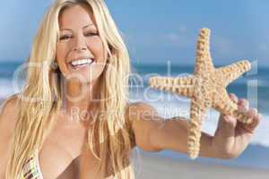 Beautiful Girl Smiling on Beach With Starfish