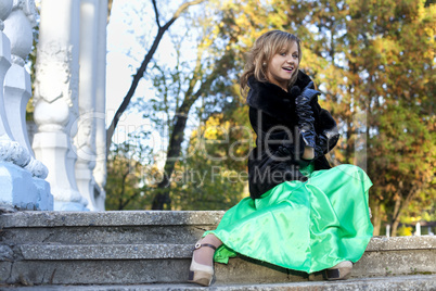 Beauty woman in green clothes and fur coat