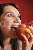 A girl biting an apple