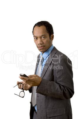 Trademan with glasses in hand using his mobile device