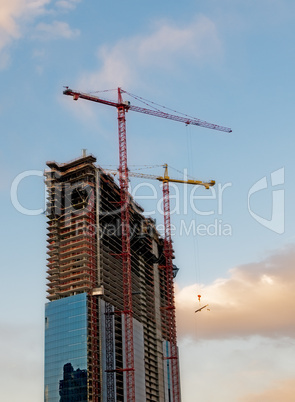 construction cranes over blue sky background