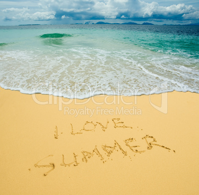 I love summer written in a sandy tropical beach