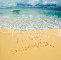 I love summer written in a sandy tropical beach