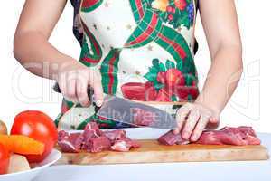 Woman cutting beef