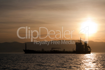 Bulk-carrier ship at sunset
