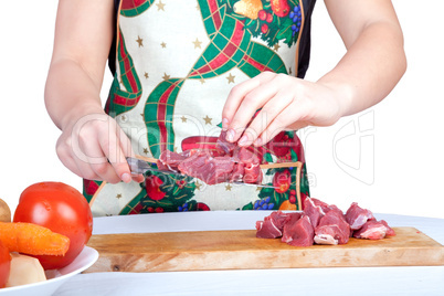 Woman cutting beef isolated on white