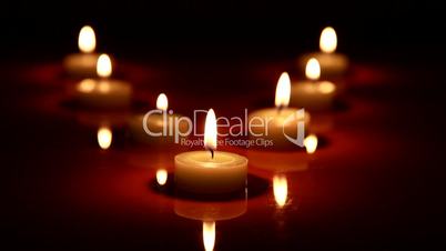 Candles are lit on a black background