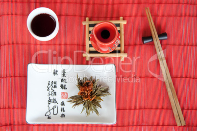 Japanese meals on red mat with wooden sticks