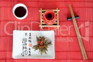 Japanese meals on red mat with wooden sticks