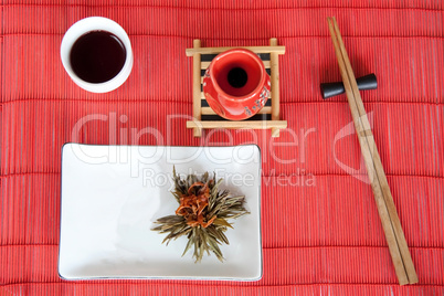 Japanese meals on red mat with wooden sticks