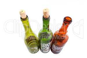 Three dusty wine bottles isolated on white