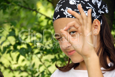 Teenage girl looking through ok sign
