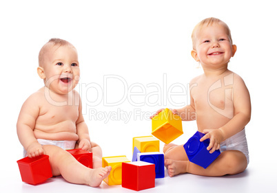 Two children play with building bricks