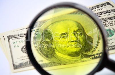 Dollars under a magnifying glass