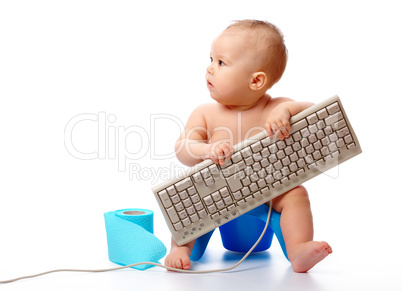 Little child is typing on keyboard