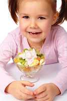 Little girl with fruit salad