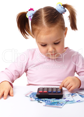 Little girl plays with money