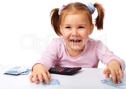 Little girl with few paper euro banknotes