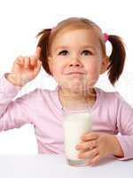 Little girl drinks milk