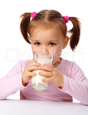 Little girl drinks milk