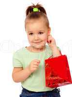 Cute little girl with red shopping bag