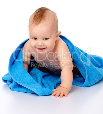 Cute child wrapped in blue towel