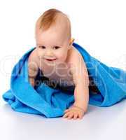 Cute child wrapped in blue towel