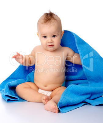 Cute child wrapped in blue towel