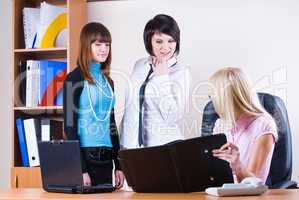 Young pretty businesswomen in office