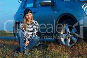Young Blond Woman With Her Broken Car