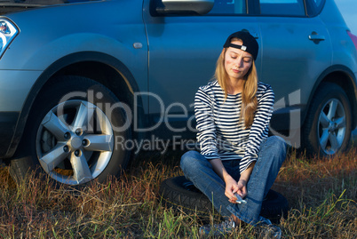 Young Blond Woman With Her Broken Car