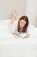 Woman reading a book on her bed