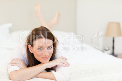 Pretty woman lying down on her bed