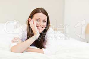 Pretty woman lying down on her bed