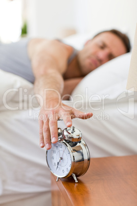 Man waking up in his bed