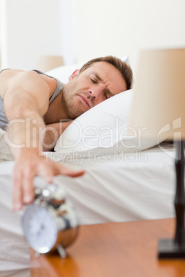 Man waking up in his bed