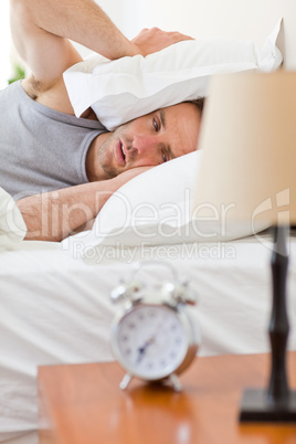 Man waking up in his bed