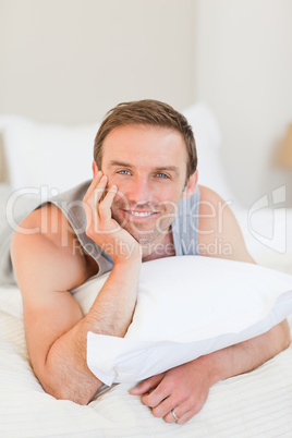 Man lying down on his bed