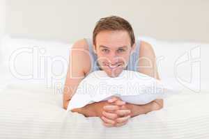 Man lying down on his bed