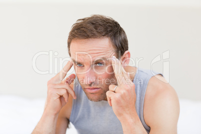 Thoughtful man sitting on his bed Thoughtful man sitting on his bed