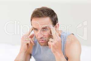 Thoughtful man sitting on his bed