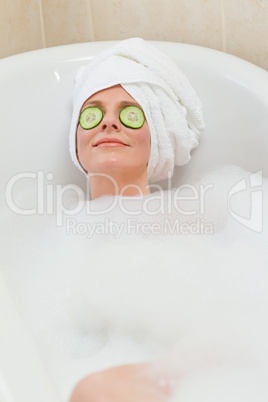 Relaxed woman taking a bath with a towel on her head Relaxed woman taking a bath with a towel on her head