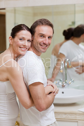 Couple hugging in the bathroom