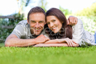 Couple lying down in the garden