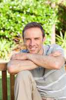 Portrait of a man sitting on a  bench