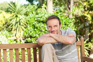 Portrait of a man sitting on a  bench