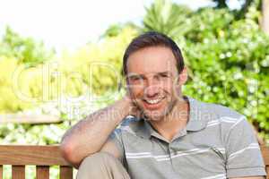 Portrait of a man sitting on a  bench