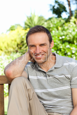 Portrait of a man sitting on a  bench